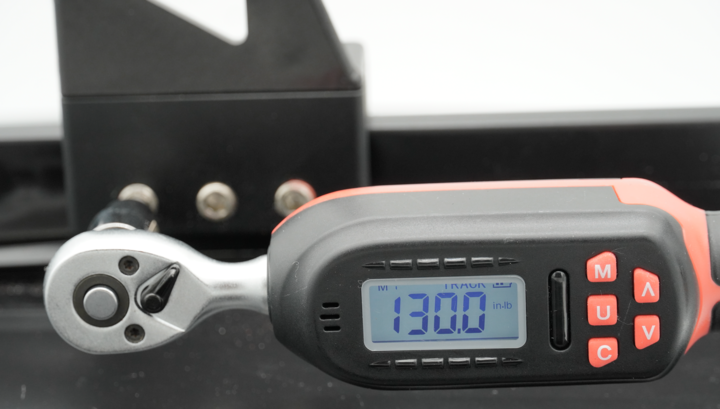 Torque wrench reading 130 in-lb on a Universal Clamp set screw