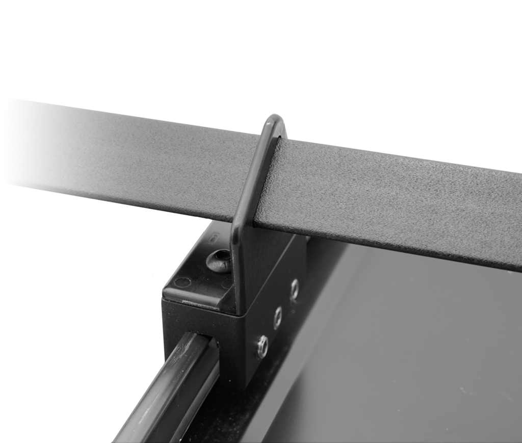 Universal Clamp locked onto a standing seam holding a snow rail
